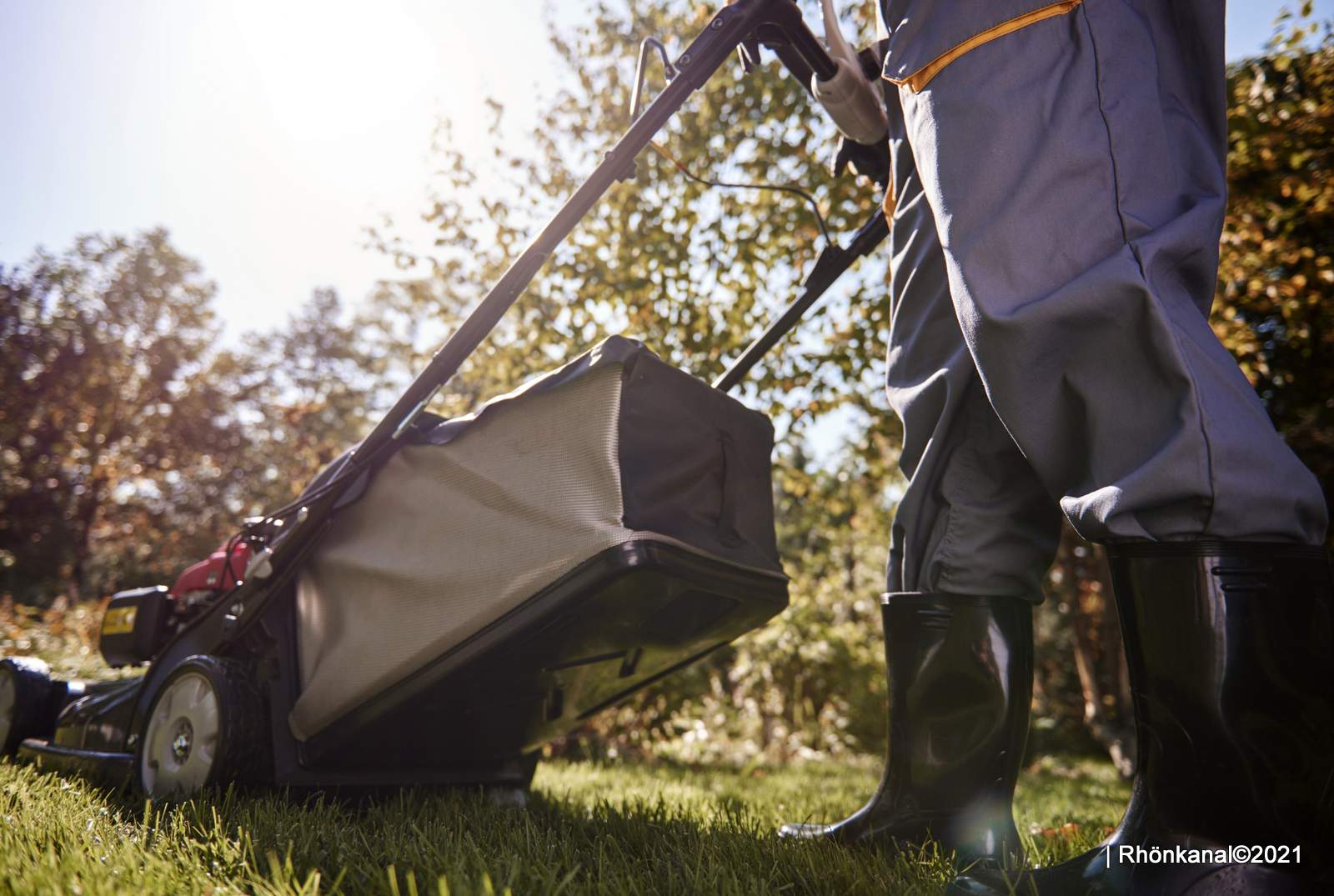 Unrecognizable man cutting the grass